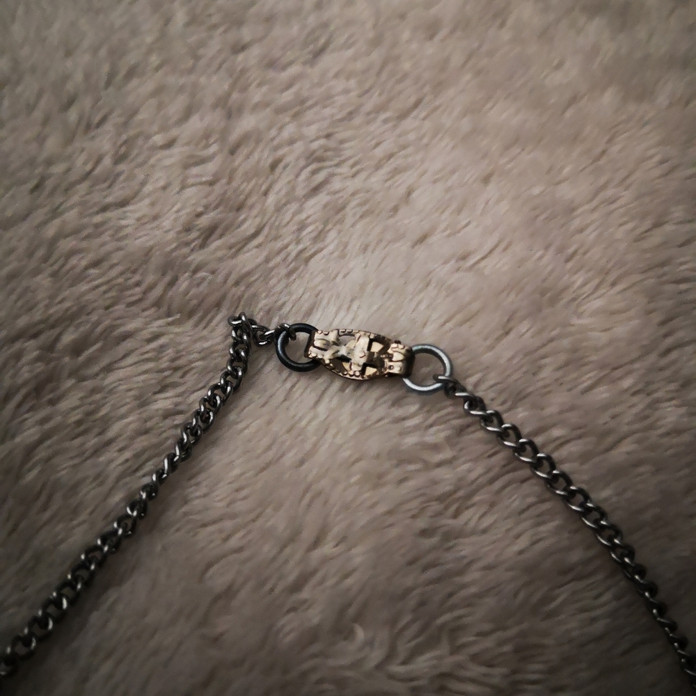 Intricate silver tone necklace